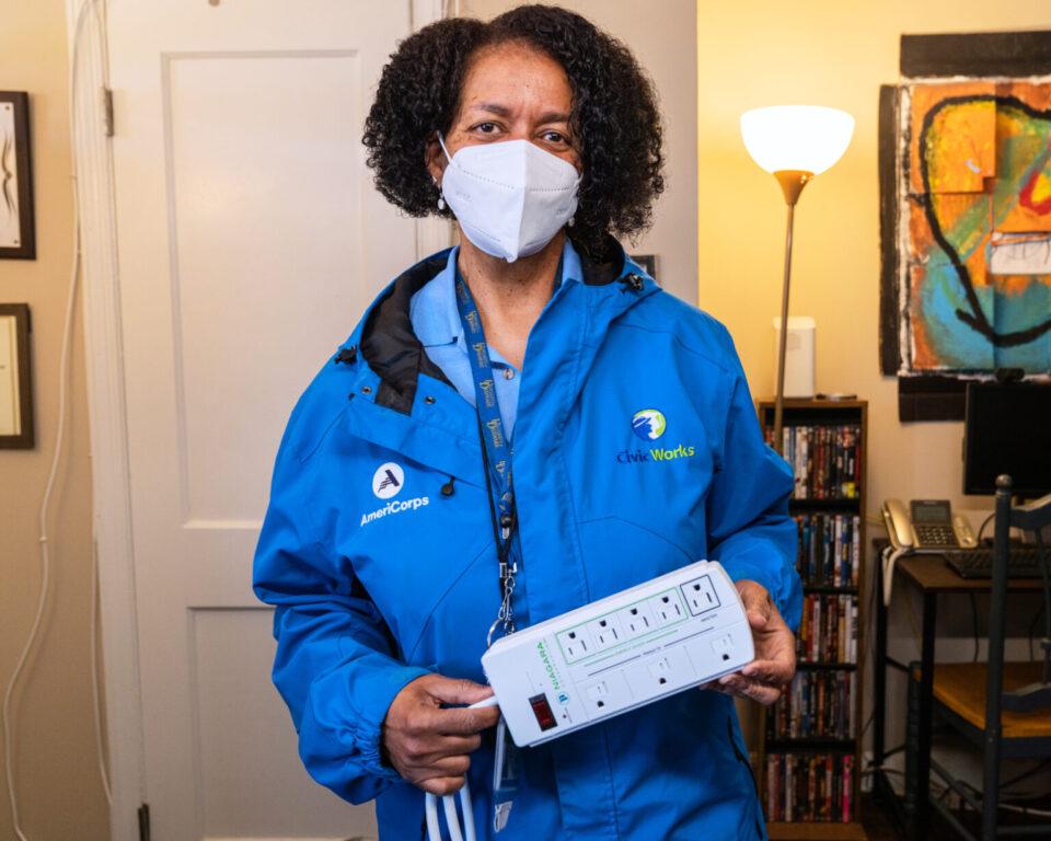 Civic Works staff member holding an advanced power strip