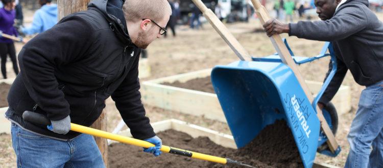 Volunteers working with raised garden beds during MLK day of service