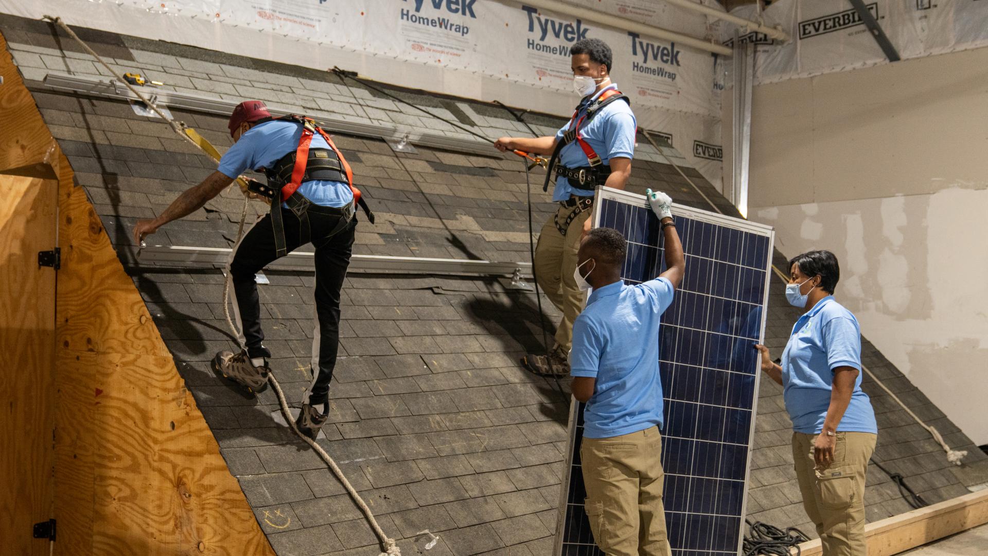 Sustainable Careers students in training installing solar panels