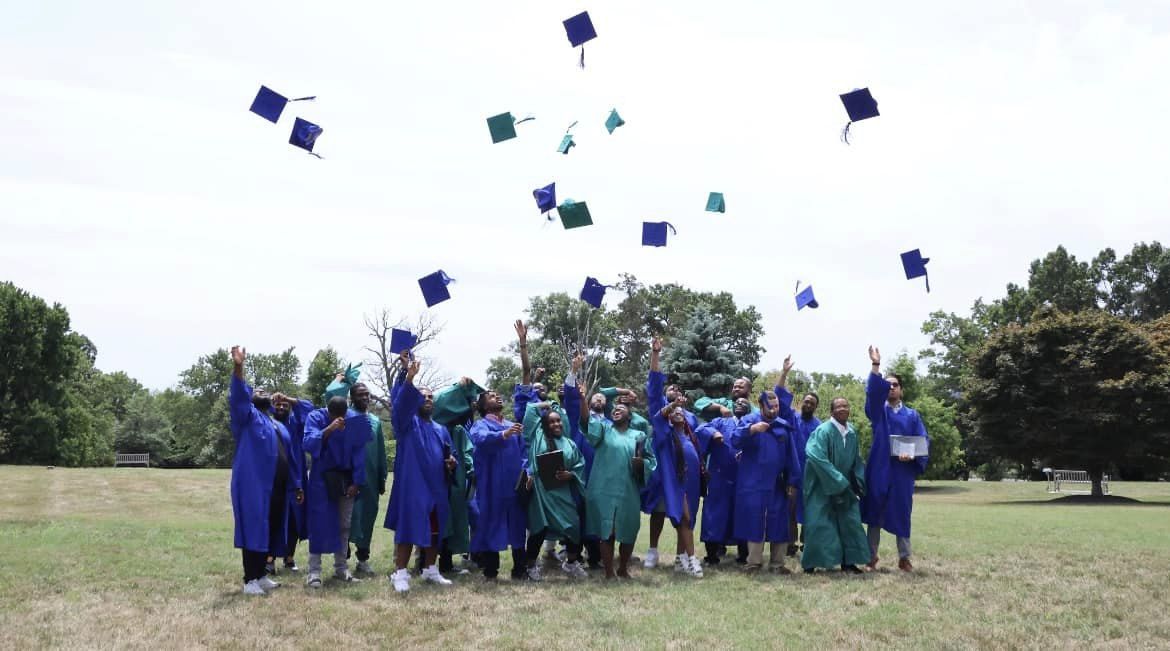 Center for Sustainable Careers graduates throwing their hats into the air