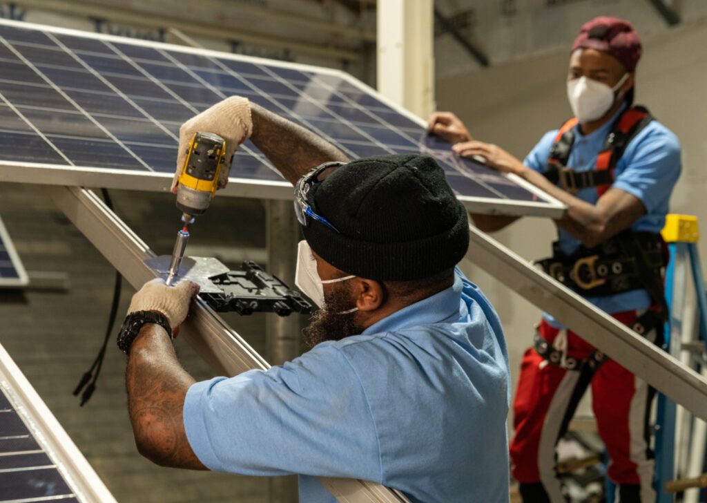 individuals working on a solar panel during training