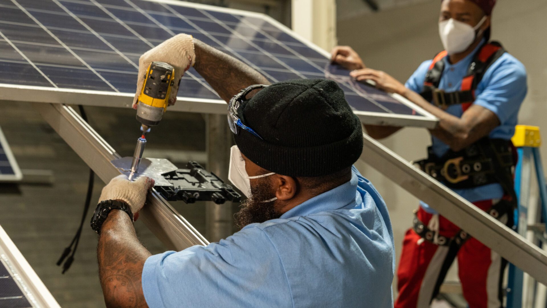 individuals working on a solar panel during training