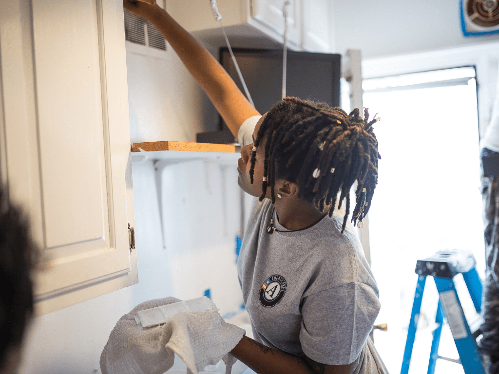 AmeriCorp intern working to upgrade an older adults home