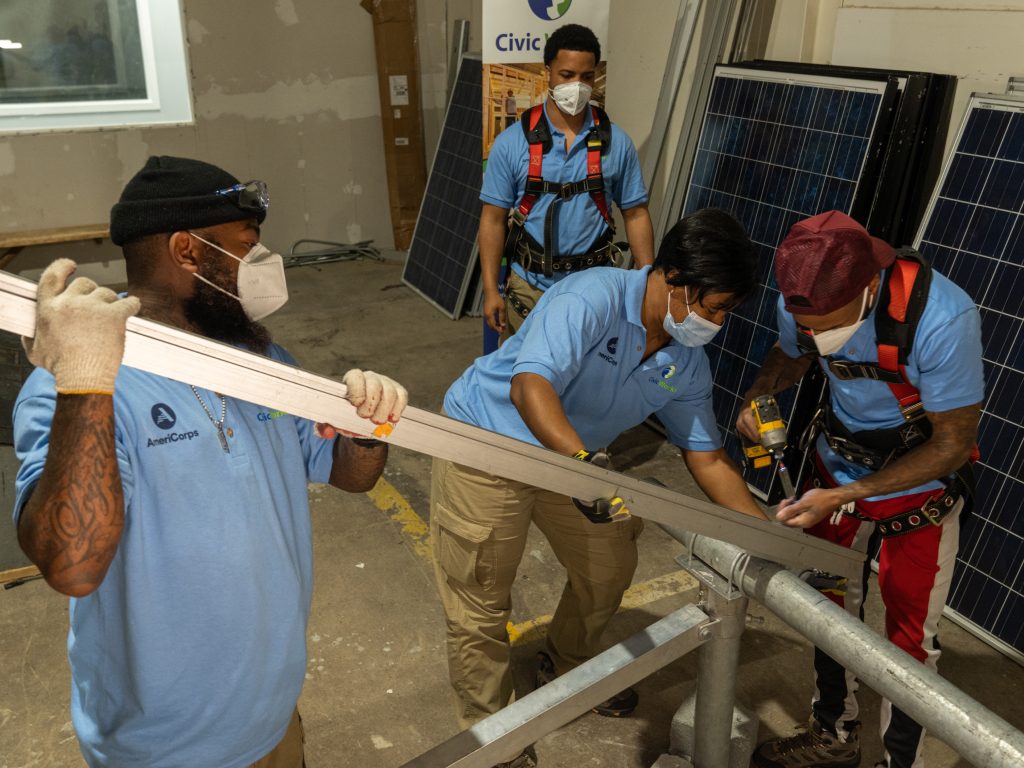 trainees learning how to install solar panels