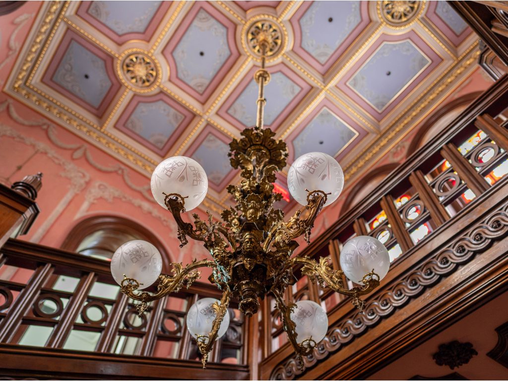 view of the chandelier in the Clifton Mansion grand stair case